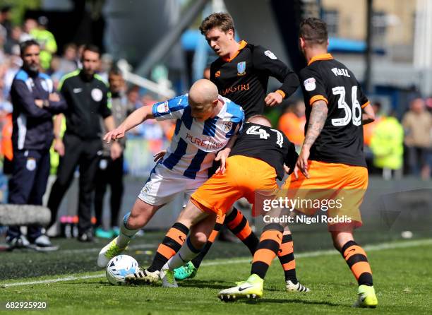 Aaron Mooy of Huddersfield Town attempts to hold off Barry Bannan of Sheffield Wednesday and Daniel Pudil of Sheffield Wednesday during the Sky Bet...