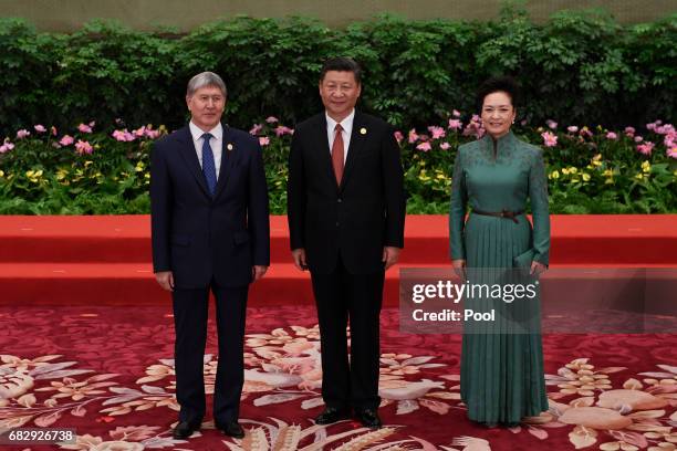 Kyrgyzstans President Almazbek Sharshenovich Atambayev poses with Chinese President Xi Jinping and his wife Peng Liyuan during a welcome ceremony for...