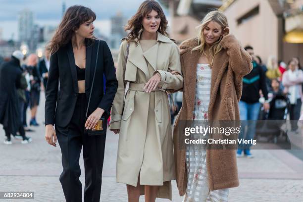 Model Georgia Fowler, model Montana Cox and Elyse Taylor wearing a trench coat outside Dion Lee during Mercedes-Benz Fashion Week Resort 18...