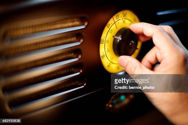 hand tuning fm retro radio knob - listening to radio stock pictures, royalty-free photos & images