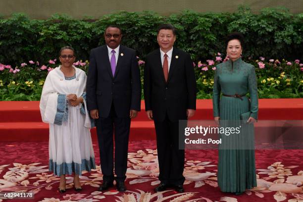 Ethiopia's Prime Minister Hailemariam Desalegn and his wife Roman Tesfaye pose with Chinese President Xi Jinping and his wife Peng Liyuan during a...