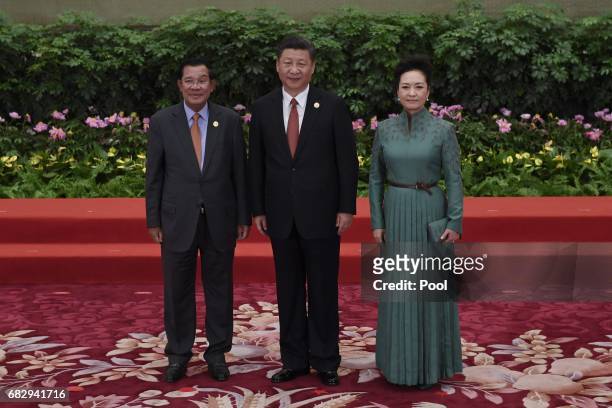 Cambodia's Prime Minister Hun Sen pose with Chinese President Xi Jinping and his wife Peng Liyuan during a welcome ceremony for leaders attending the...