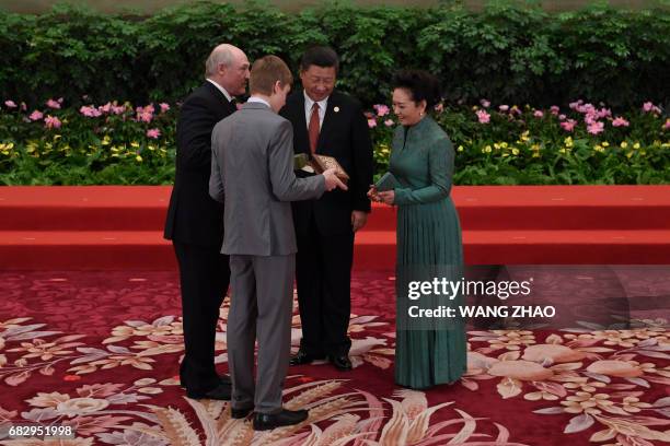 Belarus President Alexander Lukashenko and his son Nikolai Kolya Lukashenko present gifts to Chinese President Xi Jinping and his wife Peng Liyuan...