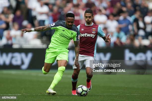 Liverpool's English defender Nathaniel Clyne takes on West Ham United's Argentinian midfielder Manuel Lanzini during the English Premier League...