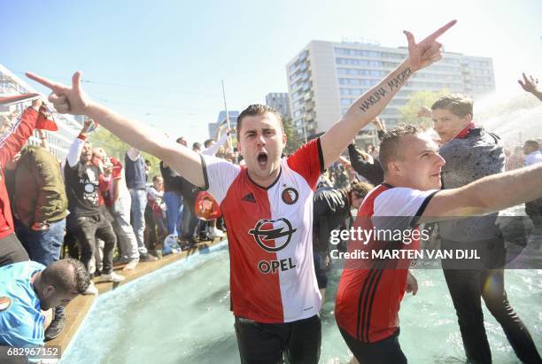 Fans of Feyenoord cheer after their club won the champions trophy during the Dutch Eredivisie match between Feyenoord Rotterdam and Heracles Almelo...