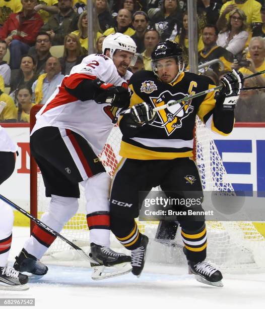 Sidney Crosby of the Pittsburgh Penguins is checked by Dion Phaneuf of the Ottawa Senators in Game One of the Eastern Conference Final during the...