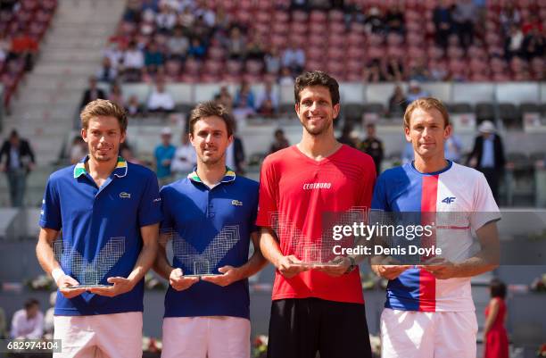 Marcelo Melo of Brazil and teammate Lukasz Kubot of Poland celebrate with their winners trophies along with with runners up Nicolas Mahut and Edouard...