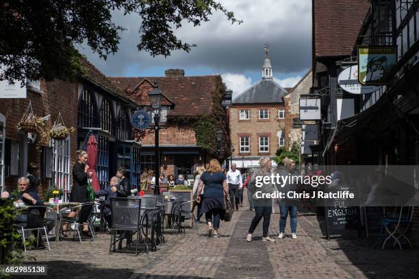 Members of the public walk past cafes and pubs in the constituency of South West Surrey on May 14, 2017 in Farnham, England. General Practioner Dr...