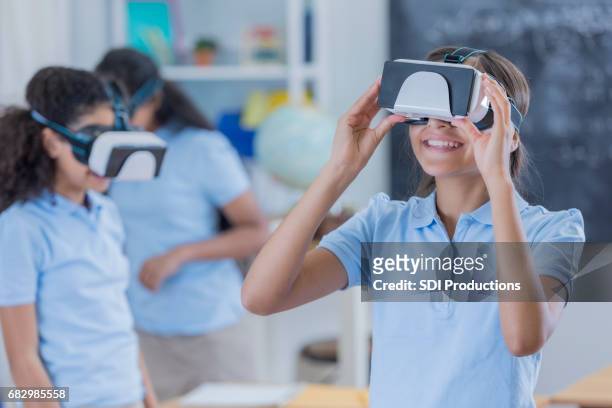 group of students uses virtual reality glasses at school - vr kids stock pictures, royalty-free photos & images