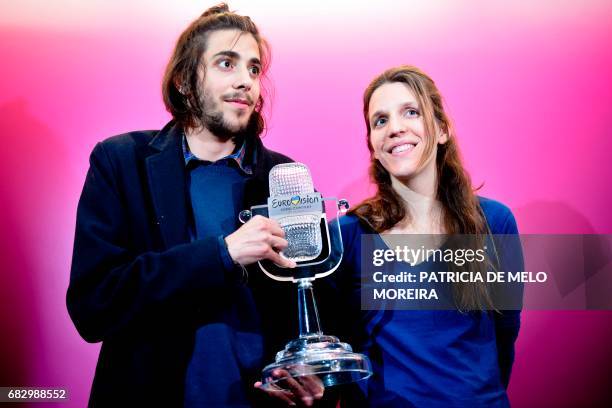 Winner of 2017 Eurovision contest Salvador Sobral accompanied by his sister Luisa Sobral pose with his trophy before a press conference upon their...