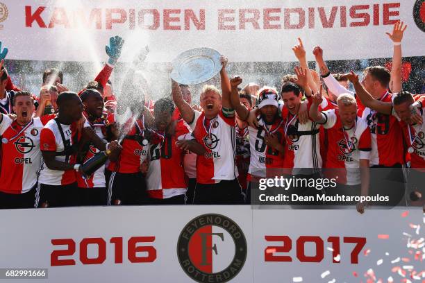 Captain, Dirk Kuyt of Feyenoord Rotterdam celebrates in front of the home fans by lifting the trophy for winning the Dutch Eredivisie at De Kuip or...