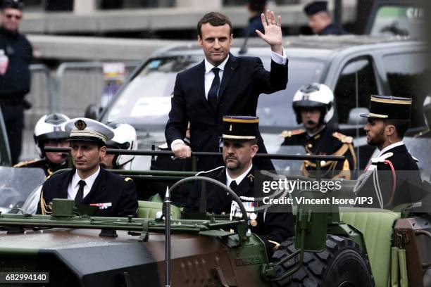 New French President elected Emmanuel Macron travels up the Champs Elysees avenue in a military vehicle in order to attend a tribute ceremony of the...