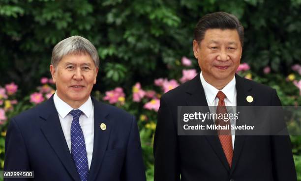 Kyrgyz President Almazbek Atambayev and Chinese President Xi Jinping pose for a photo prior to the dinner during the Belt and Road Forum for...