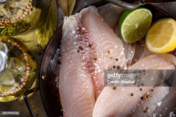 raw tilapia fillet with spices - tilapia stock pictures, royalty-free photos & images