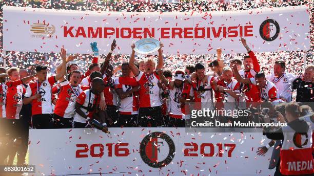 Captain, Dirk Kuyt of Feyenoord Rotterdam celebrates in front of the home fans by lifting the trophy for winning the Dutch Eredivisie at De Kuip or...