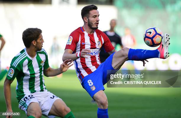 Atletico Madrid's midfielder Saul Niguez controls the ball past Betis' Serbian midfielder Darko Brasanac during the Spanish league football match...