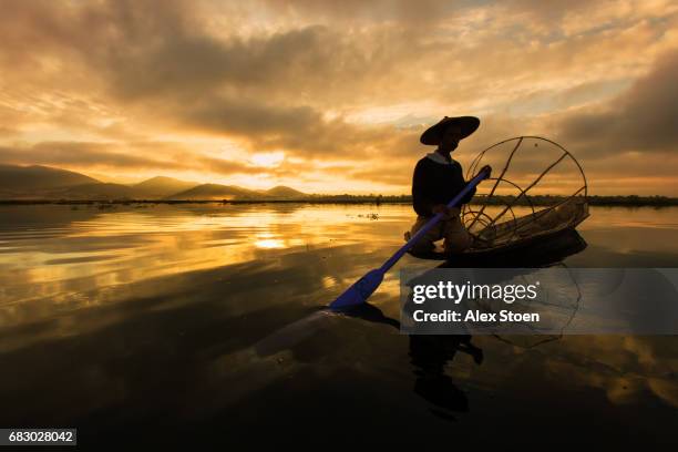 fisherman on inle lake - google social networking service stock pictures, royalty-free photos & images