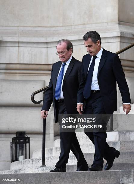 French former President Nicolas Sarkozy walks alongside former chief of police for the Paris Prefecture, Michel Gaudin, as he leaves the "Petit...