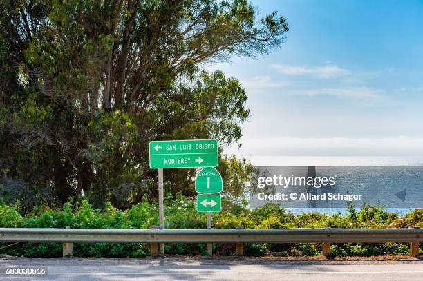 directional signs along highway 1 in big sur california - big sur stock-fotos und bilder