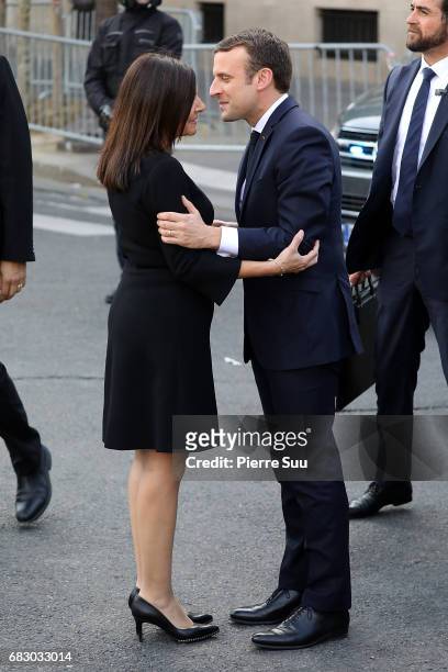 French President Emmanuel Macron is greeted by Paris Mayor Anne Hidalgo as he arrives at the City Hall for an official ceremony after his formal...