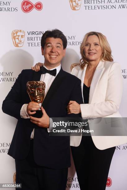 Michael McIntyre and Kim Cattrall pose with the award for Entertainment Performance in the Winner's room at the Virgin TV BAFTA Television Awards at...