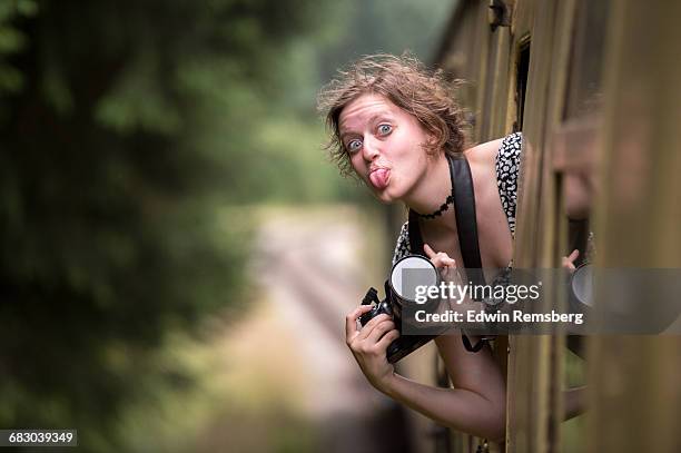 young girl making a funny face on a train - off beat stock pictures, royalty-free photos & images