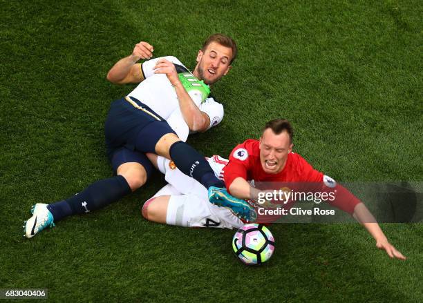 Harry Kane of Tottenham Hotspur and Phil Jones of Manchester United battle for possession during the Premier League match between Tottenham Hotspur...