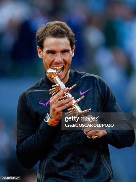 Spanish tennis player Rafael Nadal celebrates his victory over Austrian tennis player Dominic Thiem at the end of their ATP Madrid Open final match...