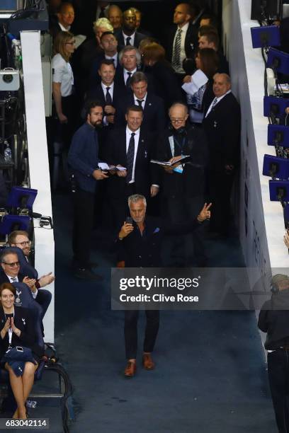 David Ginola films with with his phone as he walks onto the pitch during the closing ceremony after the Premier League match between Tottenham...