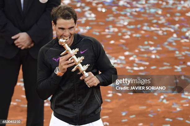 Spanish tennis player Rafael Nadal poses with his trophy as he celebrates his victory over Austrian tennis player Dominic Thiem at the end of their...