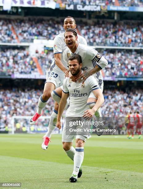 Nacho Fernandez of Real Madrid celebrates with his teammates Sergio Ramos and Danilo after scoring the opening goal during the La Liga match between...