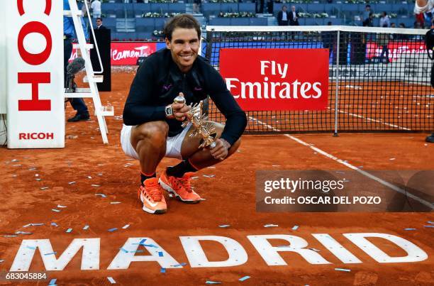 Spanish tennis player Rafael Nadal poses with his trophy as he celebrates his victory over Austrian tennis player Dominic Thiem at the end of their...