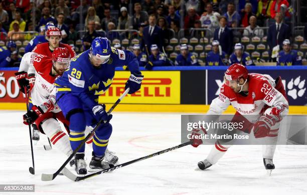 Markus Lauridsen of Denmark challenges William Nylander of Sweden for the puck during the 2017 IIHF Ice Hockey World Championship game between...