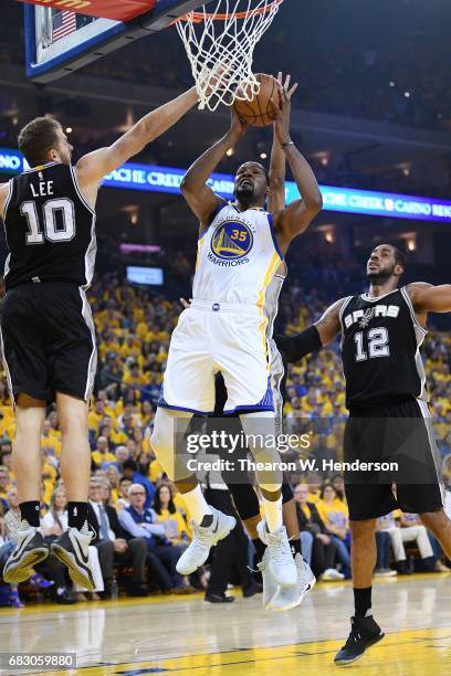 Kevin Durant of the Golden State Warriors goes up for a shot against David Lee of the San Antonio Spurs during Game One of the NBA Western Conference...