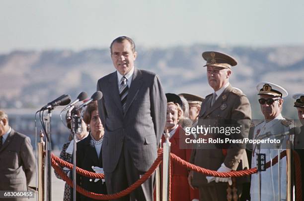 President of the United States, Richard Nixon stands next to General Francisco Franco Caudillo of Spain as he delivers a speech on a podium at...