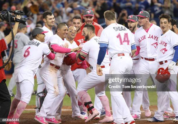 Kevin Pillar of the Toronto Blue Jays is congratulated by teammates after hitting a game-winning solo home run in the ninth inning during MLB game...