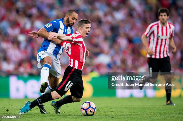 Nabil El Zhar of Club Deportivo Leganes competes for the ball with Iker Muniain of Athletic Club during the La Liga match between Athletic Club...