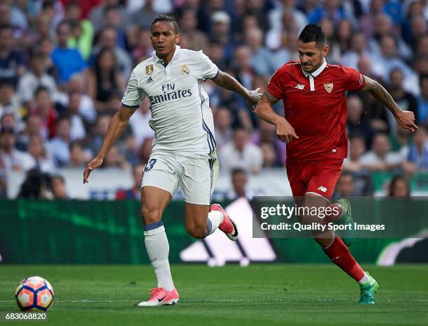 Danilo of Real Madrid competes for the ball with Vitolo of Sevilla during the La Liga match between Real Madrid CF and Sevilla CF at Estadio Santiago...