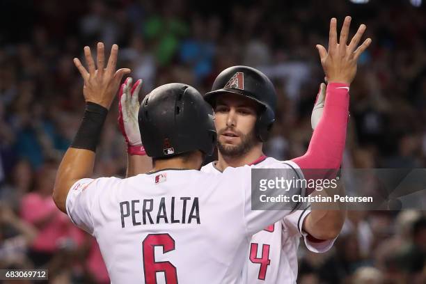 Paul Goldschmidt of the Arizona Diamondbacks high fives David Peralta after hitting a two run home run against the Pittsburgh Pirates during the...