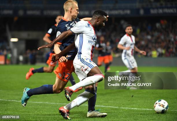 Montpellier's Czech defender Lukas Pokorny vies with Lyon's French forward Maxwel Cornet during the French L1 football match between Montpellier and...