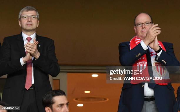 Monaco's Russian President Dmitriy Rybolovlev and Prince Albert II of Monaco applaud as they celebrate Monaco's victory at the end of the French L1...