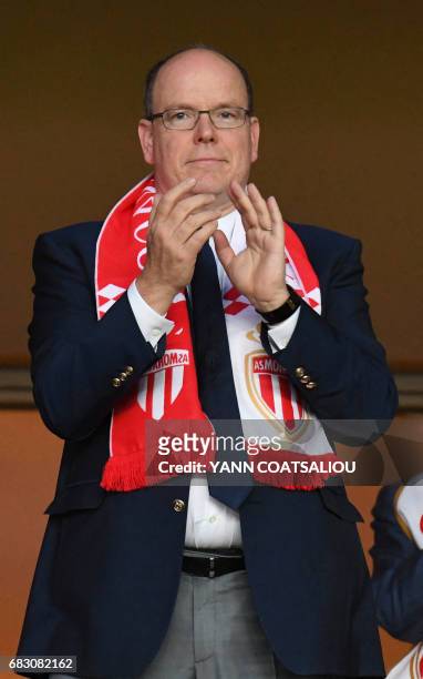 Prince Albert II of Monaco applauds as he celebrates Monaco's victory at the end of the French L1 football match between AS Monaco and LOSC Lille at...