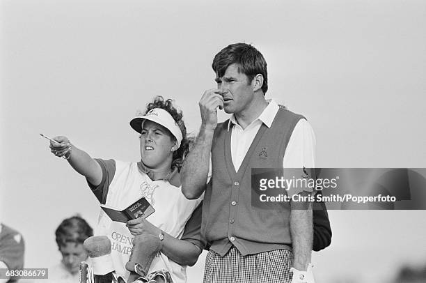 English golfer Nick Faldo pictured with his caddy Fanny Sunesson during competition to win the 1990 Open Championship by five strokes to become...