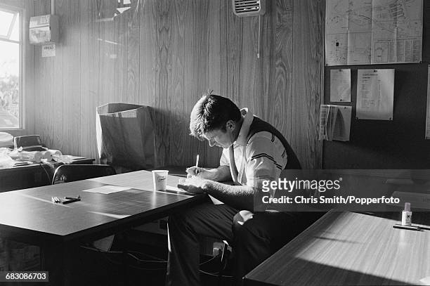 English golfer Nick Faldo pictured signing his card in the clubhouse after finishing in first place to win the 1990 Open Championship by five strokes...