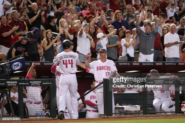 Manager Torey Lovullo of the Arizona Diamondbacks high fives Paul Goldschmidt after Goldschmidt hit a solo home run against the Pittsburgh Pirates...