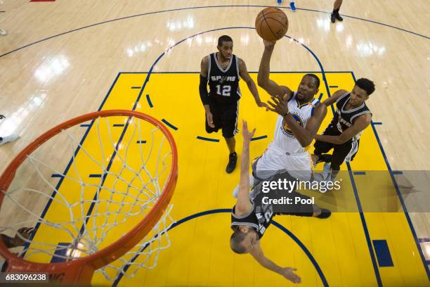 Manu Ginobili of the San Antonio Spurs draws a charge from Kevin Durant of the Golden State Warriors during Game One of the NBA Western Conference...