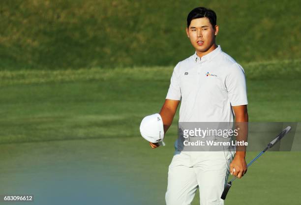 Si Woo Kim of South Korea celebrates on the 18th green after finishing 10 under to win during the final round of THE PLAYERS Championship at the...