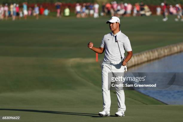 Si Woo Kim of South Korea celebrates on the 18th green after finishing 10 under to win during the final round of THE PLAYERS Championship at the...
