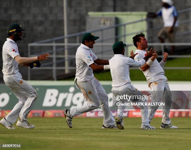 Members of the Pakistan cricket team celebrate with final wicket taker Yasir Shah after winning the final test match and the series 2-1 against the...