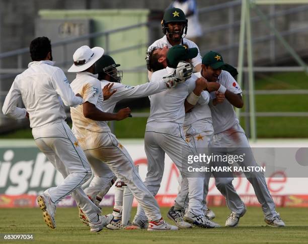 Members of the Pakistan cricket team celebrate with final wicket taker Yasir Shah after winning the final test match and the series 2-1 against the...